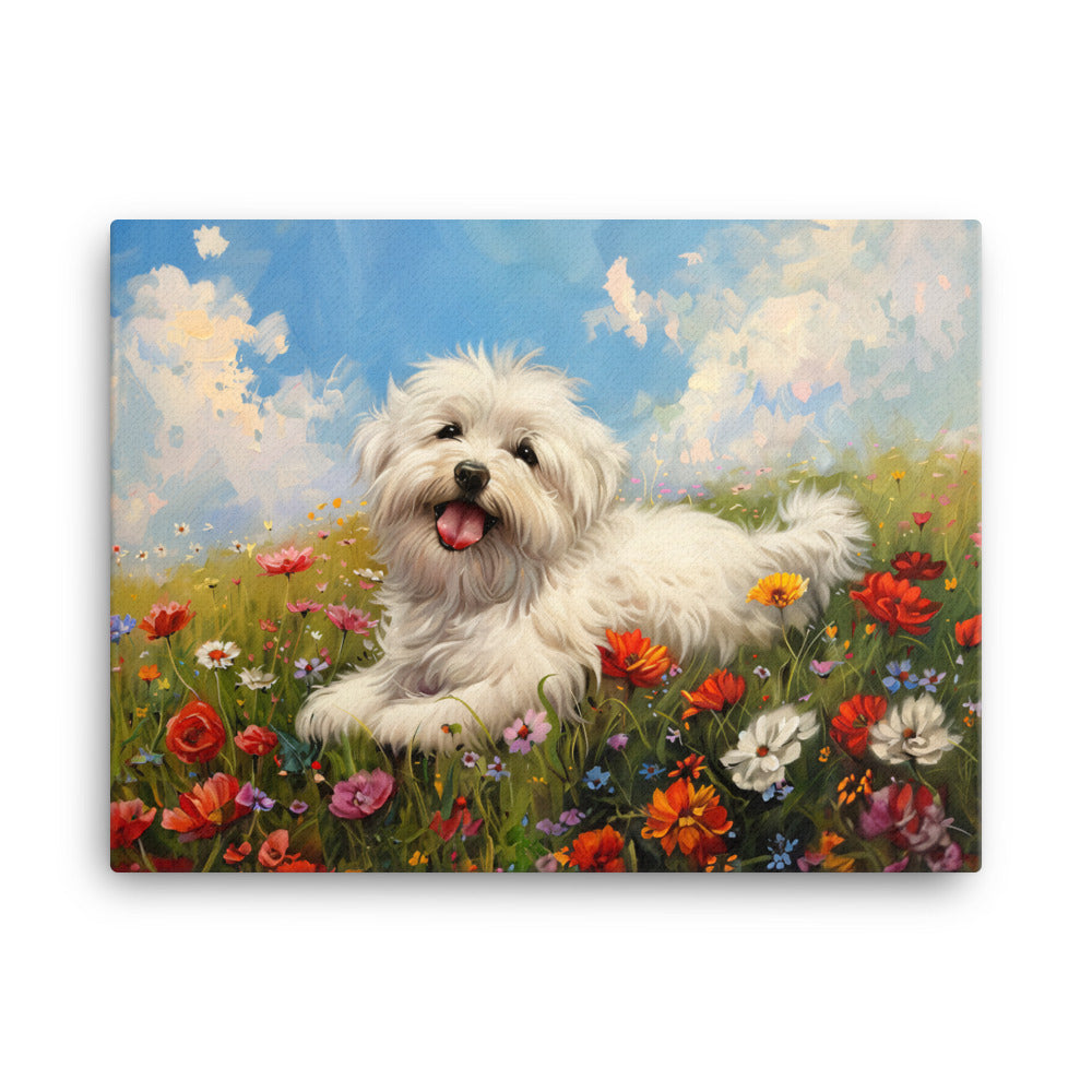 A happy coton de tulear sits on a grass hill with wildflowers.